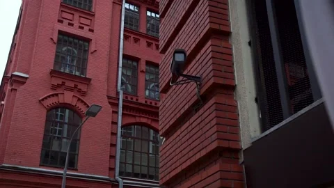 CCTV camera on facade of industrial building on summer day. Media. The walls of 스톡 동영상 141461565