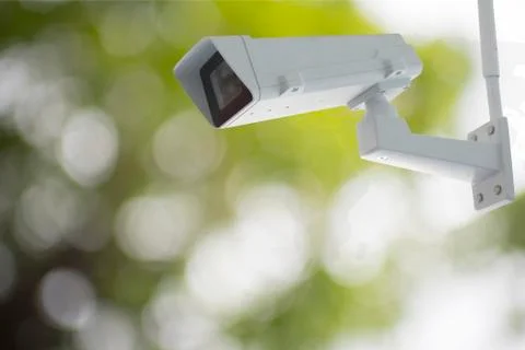Cctv camera with green blur background Stock Photos