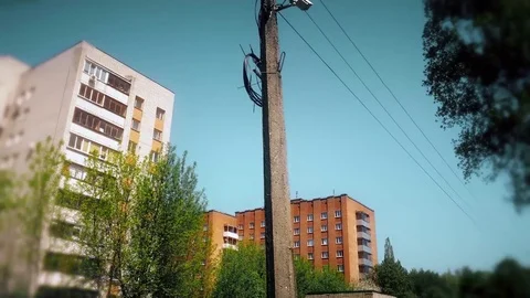 CCTV camera hanging on a pole on blue sky background Stock Footage 75447047