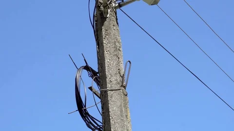 CCTV camera hanging on a pole on blue sky background Stock Footage 75447166