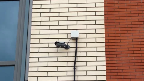 CCTV camera installed on the brick wall of the building Stock Footage 195935062