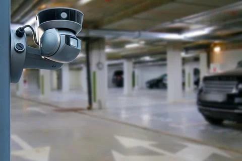 Cctv camera installed on the parking lot to protection security. Copy space. Stock Photos