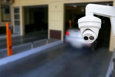 Cctv camera installed on the parking lot to protection security. Copy space. Stock Photos