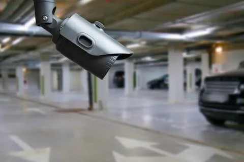 Cctv camera installed on the parking lot to protection security. Copy space. Stock Photos