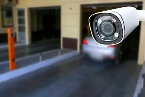 Cctv camera installed on the parking lot to protection security. Copy space. Stock Photos