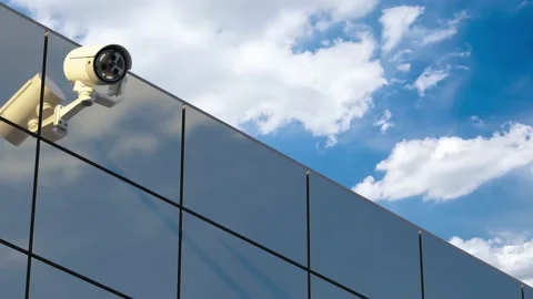 CCTV camera installed on wall of the building and Sky Time-lapse background.  Video stock 227729125