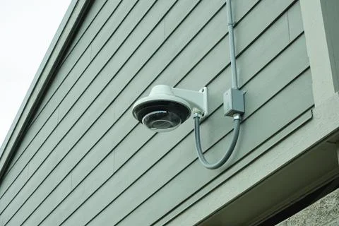 CCTV camera installed on the wall of a building. Stock Photos