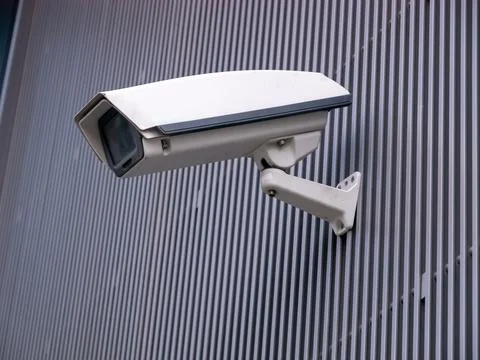 CCTV camera isolated on gray striped background. Stock Photos