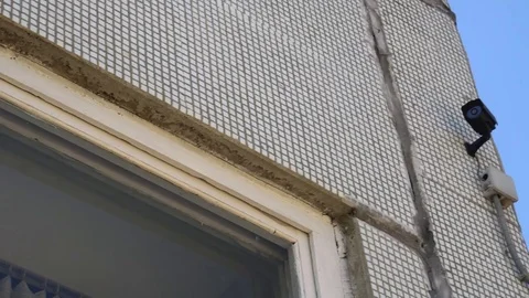 CCTV camera located on the wall of the school building Stock Footage 75446152