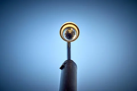 A CCTV Camera looks down menacingly Stock Photos