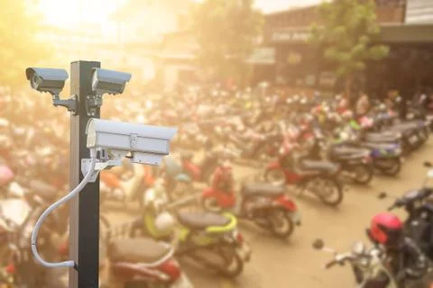 CCTV camera operating in car or motorcycle parking ,Concept Security in condo Stock Photos