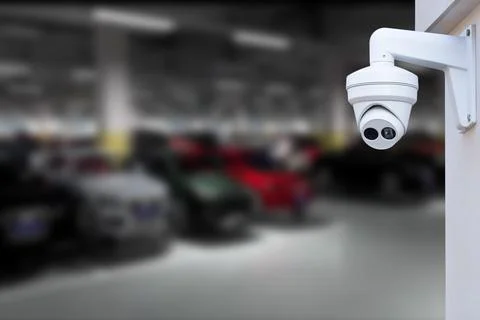 CCTV Camera Operating in car park building. Copy space. Stock Photos