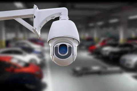 CCTV Camera Operating in car park building. Copy space. Stock Photos
