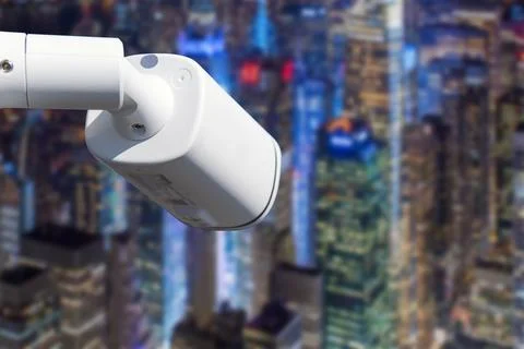 CCTV Camera Operating with city in background. Stock Photos