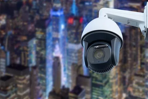CCTV Camera Operating with city in background. Stock Photos