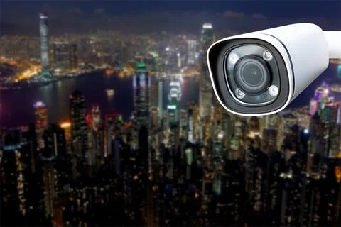 CCTV Camera Operating with city in background. Stock Photos