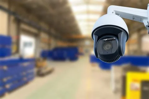CCTV Camera or surveillance operating inside industrial factory. Copy space. Stock Photos