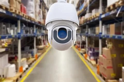 CCTV camera or surveillance operating in store or warehouse. Stock Photos