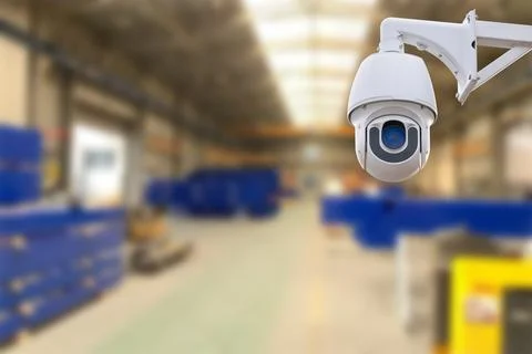 CCTV Camera or surveillance operating inside industrial factory. Copy space. Stock Photos