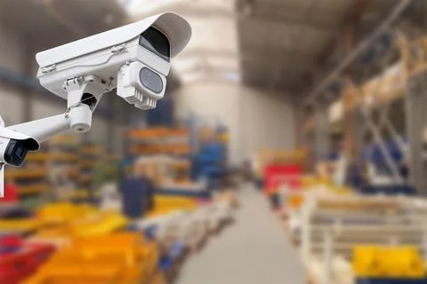 CCTV Camera or surveillance operating inside industrial factory. Copy space. Stock Photos