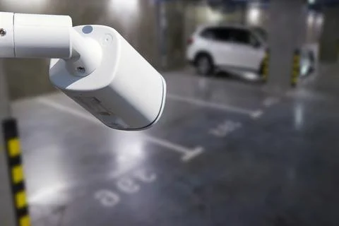 CCTV camera or surveillance system on indoor car parking. Stock Photos