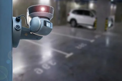 CCTV camera or surveillance system on indoor car parking. Stock Photos
