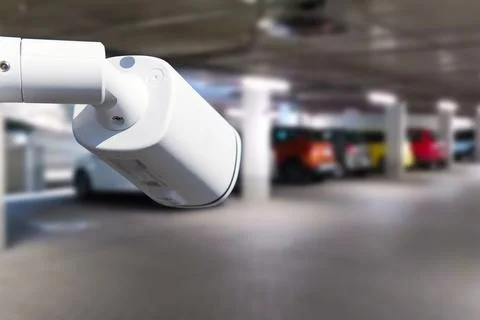 CCTV camera or surveillance system on indoor car parking. Stock Photos