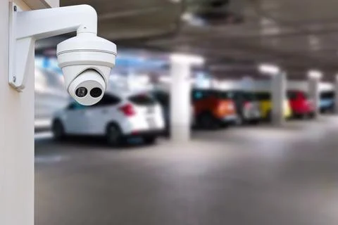 CCTV camera or surveillance system on indoor car parking. Stock Photos