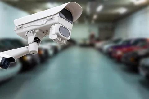 CCTV camera or surveillance system on indoor car parking. Stock Photos