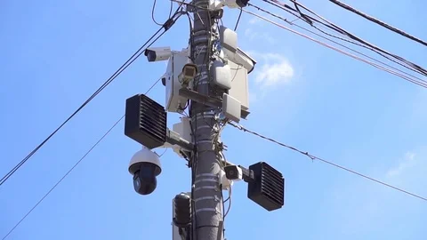 CCTV camera on the pillar watches what is happening on the street. Close up 動画素材 78533908