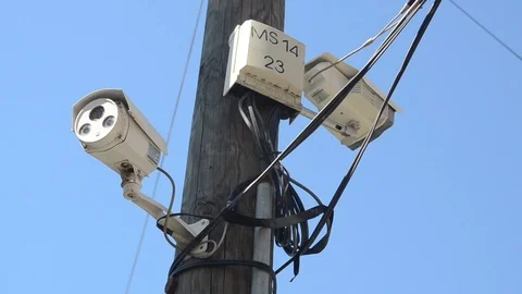 CCTV camera on the pole with blue sky. Professional Surveillance Security camera Stock Footage 116669779
