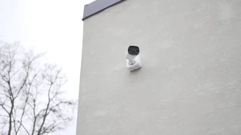 CCTV camera records activity outdoor building in autumn city Видео 313831010