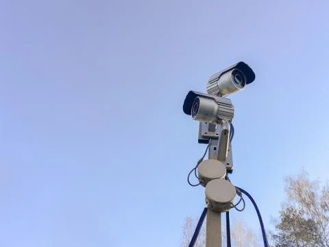 Cctv camera security on pole and cement background Stock Photos