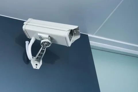 Cctv camera security on wall background for safety concept Stock Photos