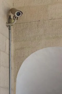 CCTV camera on stone wall with arch Stock Photos