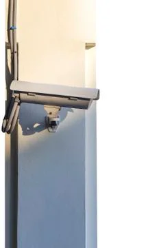 CCTV camera on wall isolated on white background. Stock Photos