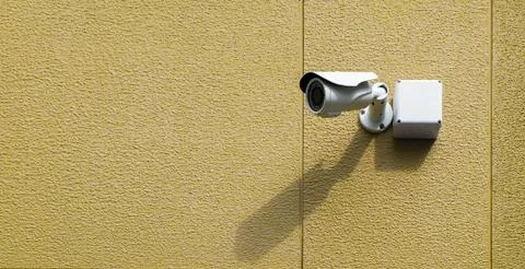 CCTV camera on the wall. Stock Photos