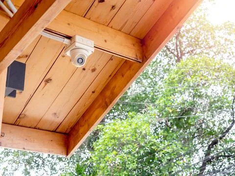 CCTV camera on wood ceiling. Stock Photos