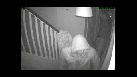 CCTV captures three burglars searching a home while the resident sleeps Stock Footage 149132383
