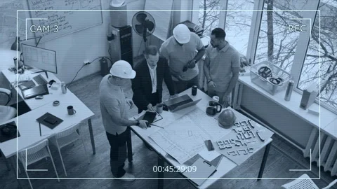 CCTV of Four Construction Engineers Analyzing Blueprints on Table in Office Stock Footage 329618379
