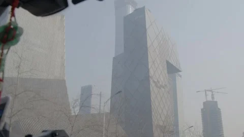 CCTV Headquarters Exterior Seen Through Vehicle Window in Hazy Beijing Cityscape Stock Footage 341712939