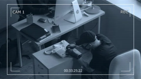 CCTV of Man Installing Listening Bug into Phone Spying in Corporate Office Stock Footage 313548847