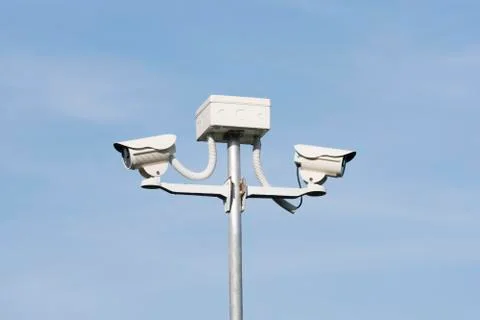 Cctv security camera on blue background, property protection Foto stock