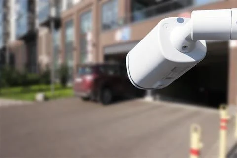 CCTV security camera on blur car parking. Stock Photos