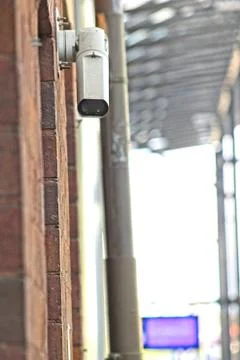 CCTV security camera on brick building watching the area Stock Photos