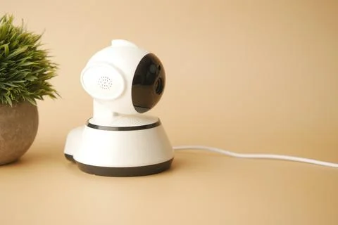 CCTV security camera operating on light orange background Stock Photos