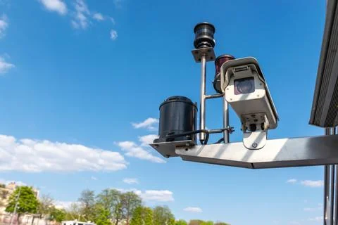 CCTV Security camera over blue sky background. - Image Stock Photos