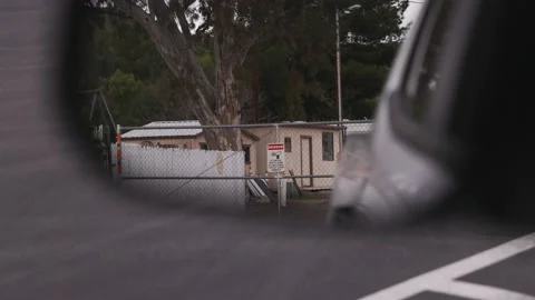 Cctv security camera sign hanging on a chain link fence in a cars side Stock Footage 237150513