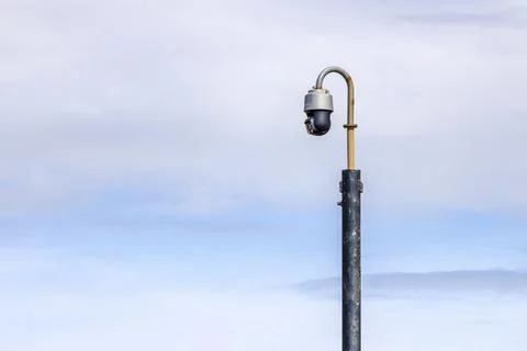 CCTV security camera tilted down with rain wiper blade on pole Stock Photos