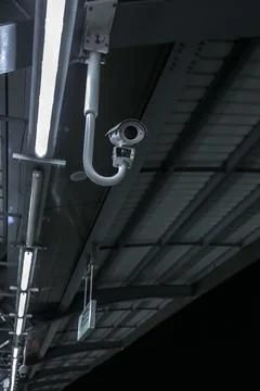 Cctv security camera at a train terminal at night time Stock Photos